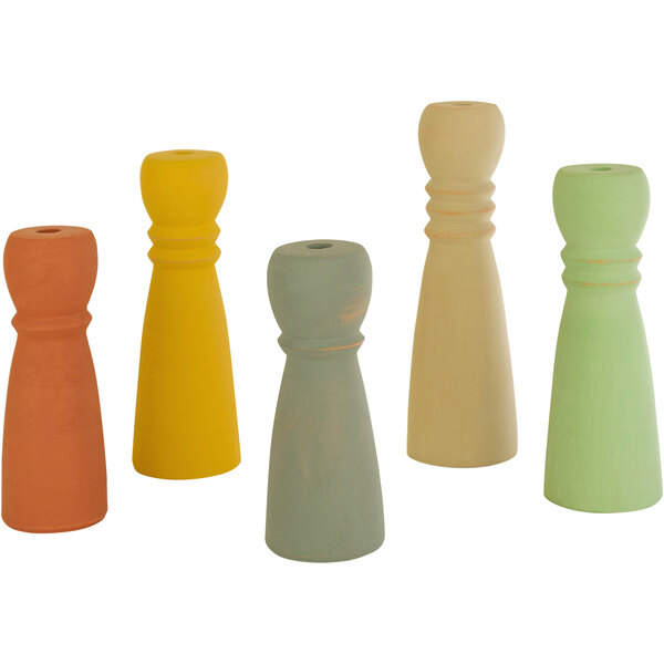 A group of four different colored ceramic candle holders.