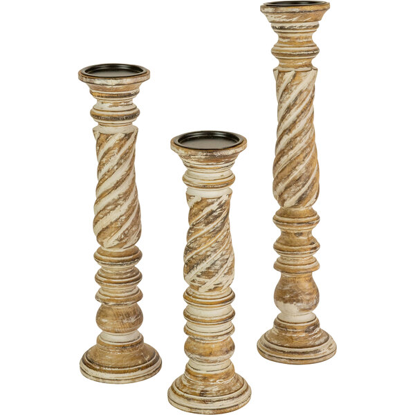 A group of Kalalou turned wooden candle holders with spiral designs.