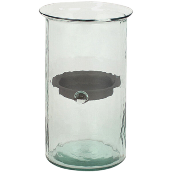 A clear glass cylindrical hurricane candle holder with a rustic metal insert.