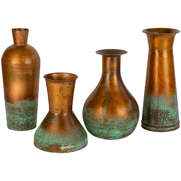A group of three copper vases with green and brown paint.