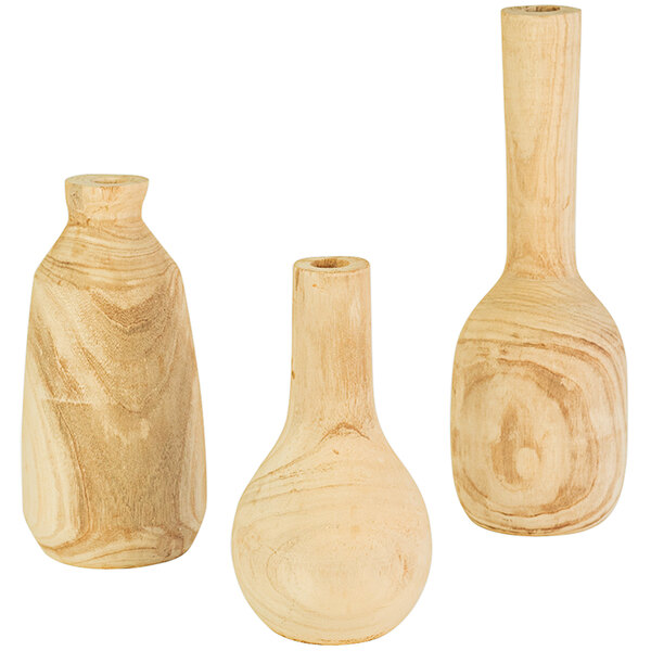 A group of three tall wooden vases.