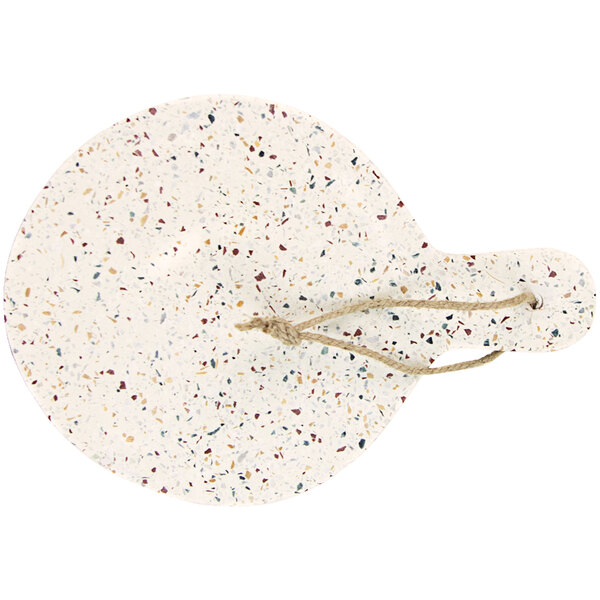A white terrazzo round serving board with a rope handle.