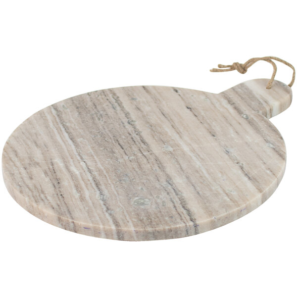 A round grey marble serving board with a handle.