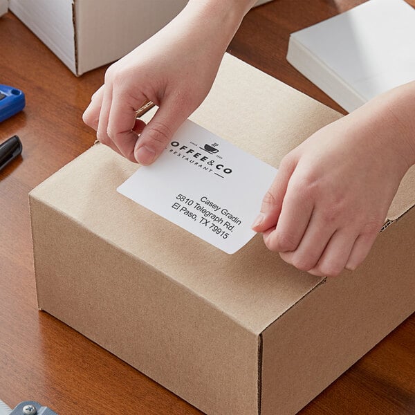 A person opening a box of Lavex thermal transfer labels.