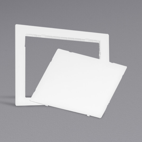 A white square Oatey access panel cover on a gray surface.