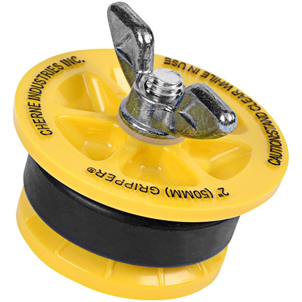 A yellow plastic Cherne End of Pipe Gripper Plug with a metal handle.