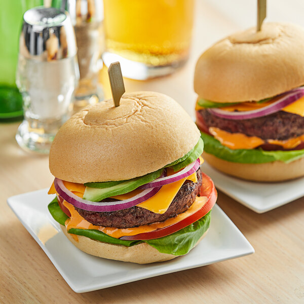 Two hamburgers on a plate with two Schar Gluten-Free hamburger buns.