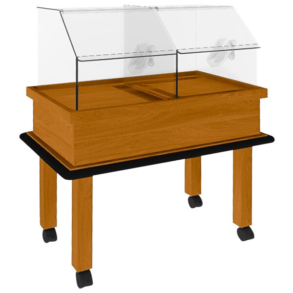 A Marco Company honey pine wooden bakery display with clear glass cover on wheels.