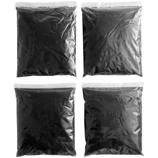 A black plastic bag with 4 black charcoal filters inside.