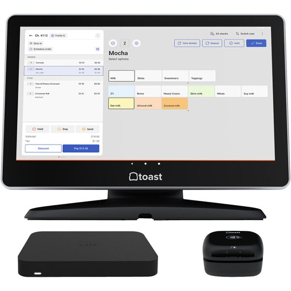 A Toast countertop POS kit on a desk with a tablet and remote.