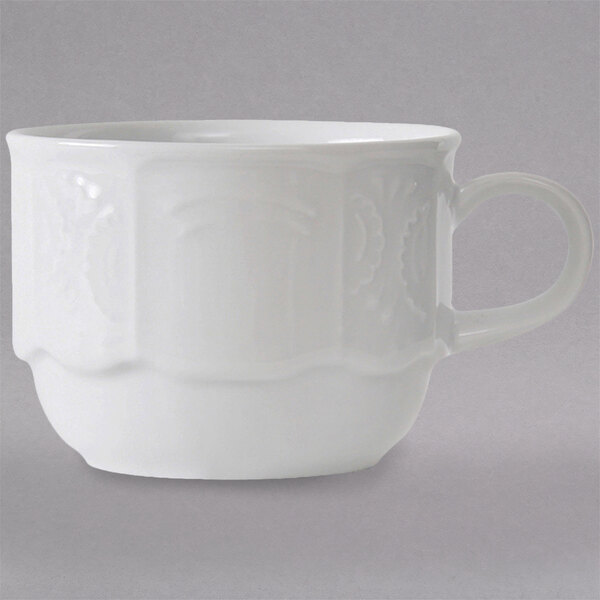 A close-up of a Tuxton bright white espresso cup with a handle.