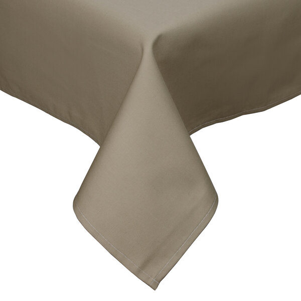 A beige Intedge rectangular table cover with a hemmed edge on a table.