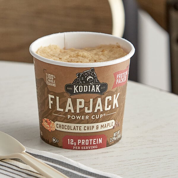 A Kodiak Cakes chocolate chip and maple flapjack cup on a table.