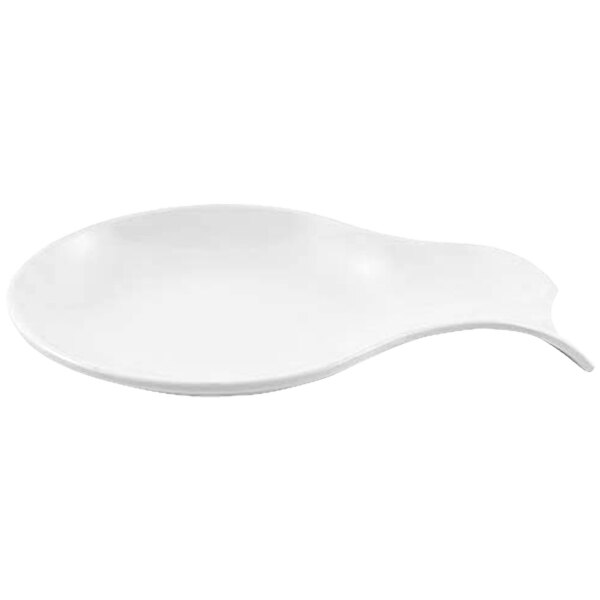 A white spoon rest with a curved edge holding a spoon.