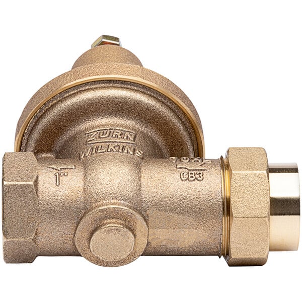 A Zurn brass water pressure reducing valve with union connections.