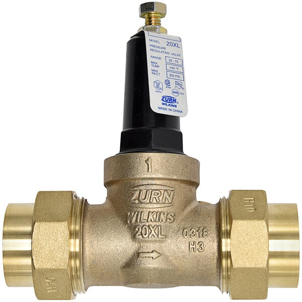 A close-up of a Zurn brass water pressure reducing valve with a black and gold label.