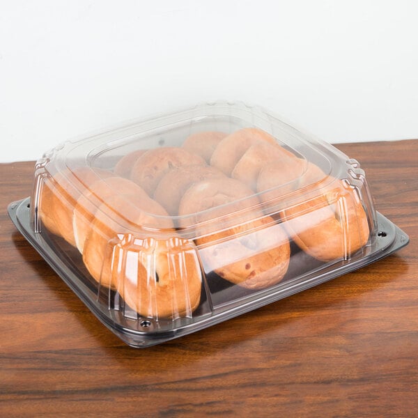 A Sabert plastic catering tray with pastries in it.
