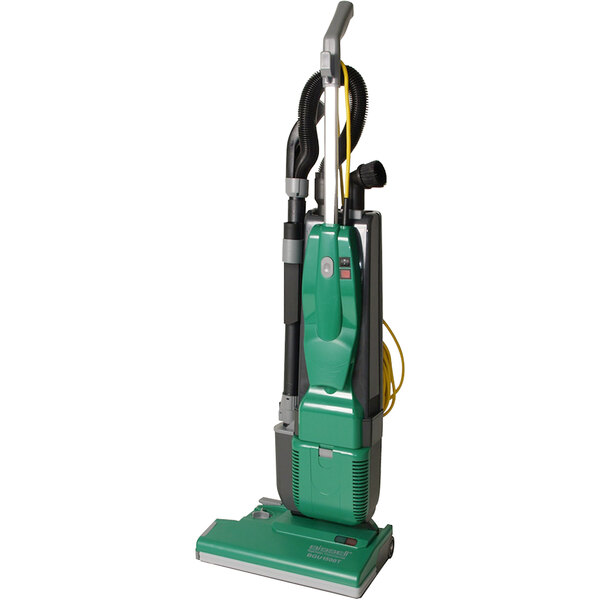 A green Bissell Commercial bagged upright vacuum cleaner with black nozzles.