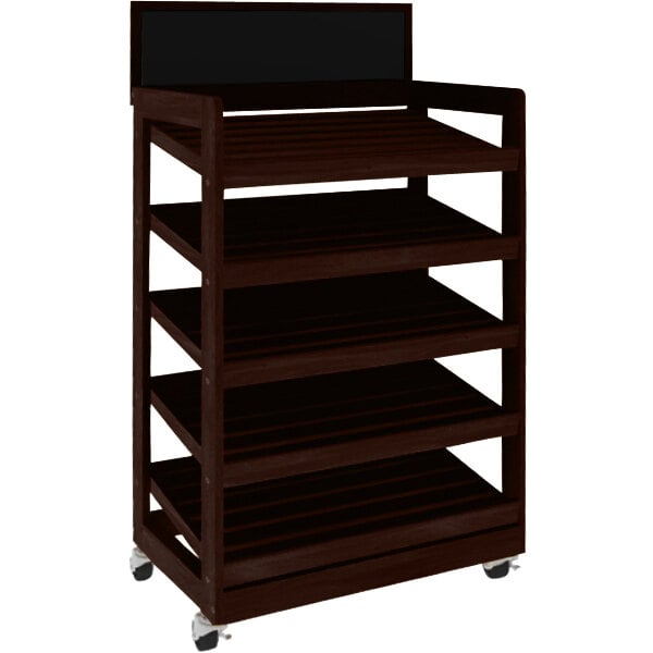 A brown wooden bakery display shelving unit with black shelves on wheels.