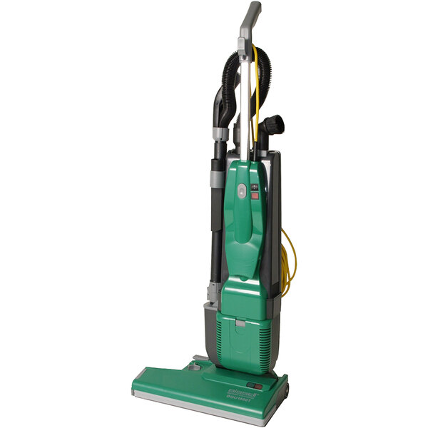 A close-up of a Bissell Commercial green vacuum cleaner with black nozzles.