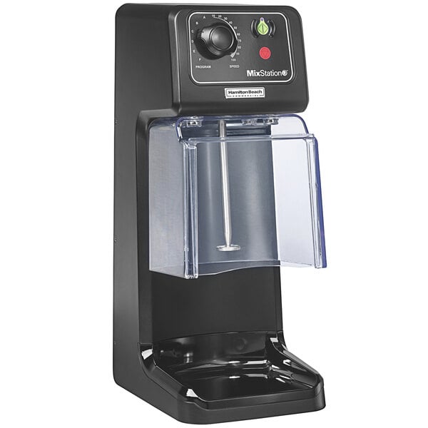 A black Hamilton Beach MixStation drink mixer with a clear plastic cover on a counter.