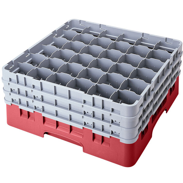 A red and gray plastic Cambro glass rack with compartments.
