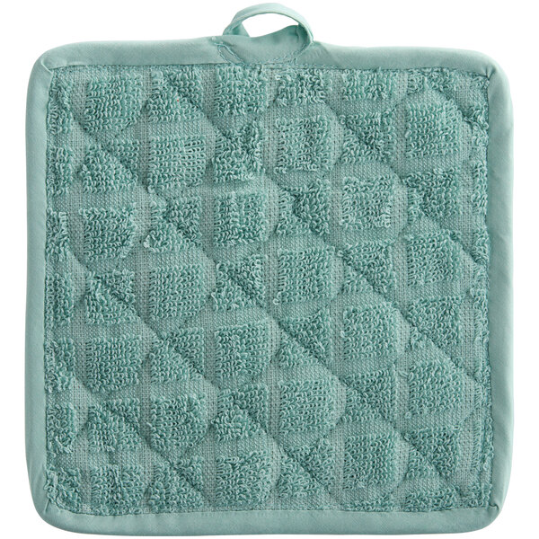 A green pot holder with a small square design.