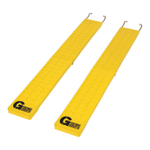 A pair of yellow GenieGrips forklift mats with black text on them.