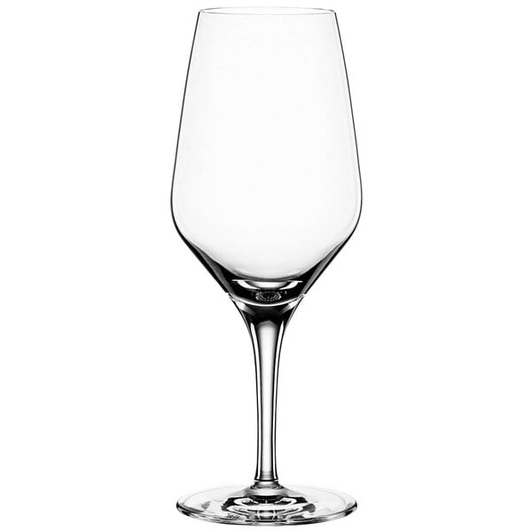 A close-up of a clear Spiegelau wine glass with a stem.
