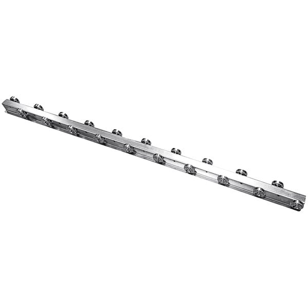 A long metal Lavex flow rail with staggered galvanized steel wheels.