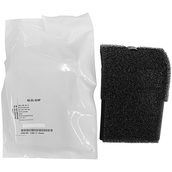 A white plastic bag with black text that contains a black and white sponge.
