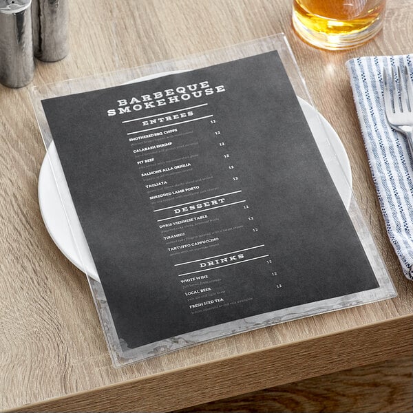A clear Choice 2-view menu cover on a table with a glass of beer.