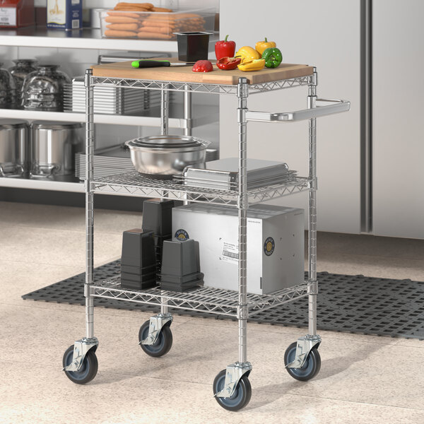 A Regency chrome utility cart with wooden shelves holding food and glass containers.