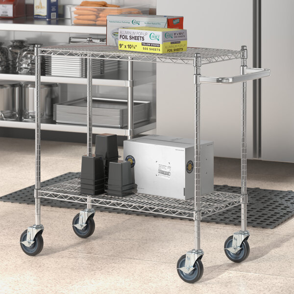 A Regency chrome utility cart with shelves and boxes on it.