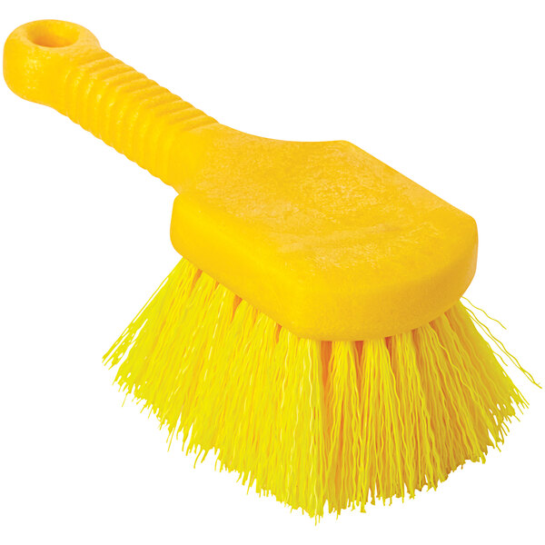 A close-up of a yellow Rubbermaid plastic utility brush with a handle.