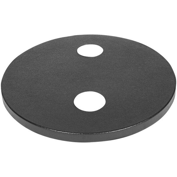 A black circle with two holes on a white surface.