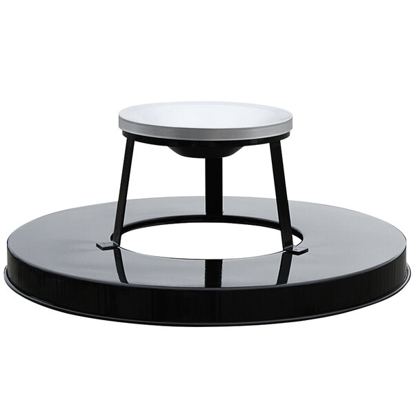 A black circular steel lid with a white ash top on a table.