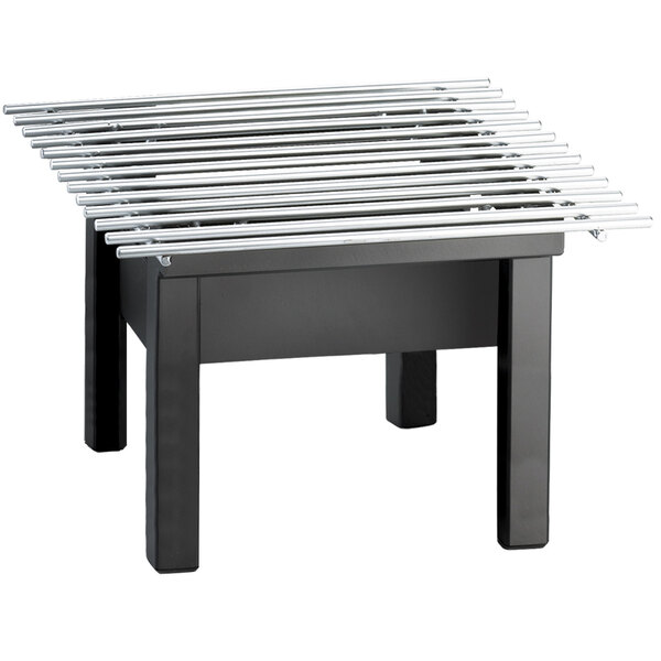 A black table with a Cal-Mil black metal griddle on top.