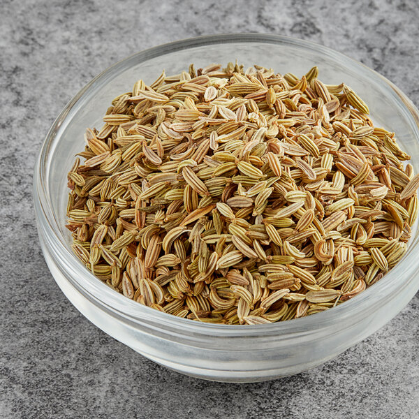 A bowl of McCormick Culinary fennel seeds on a table.