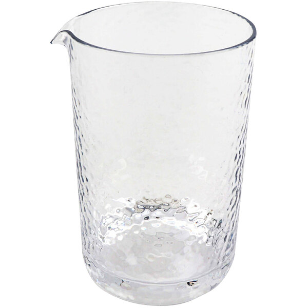 A clear plastic mixing glass with a handle.