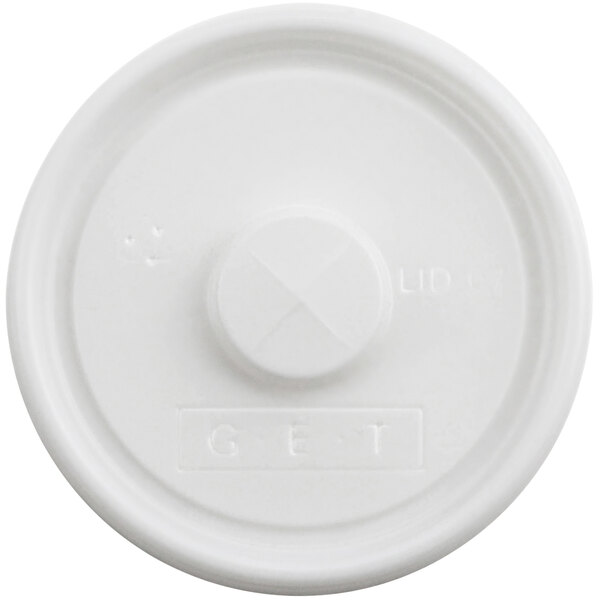 A white plastic lid with a small cross on it.