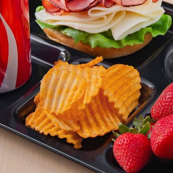 A tray with a sandwich, strawberries, a Martin's Bar-B-Q Waffle Potato Chip bag, and a drink on a counter.