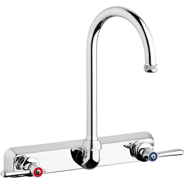 A silver Chicago Faucets wall-mounted faucet with red and silver knobs.