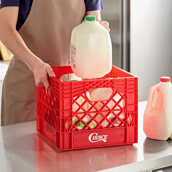 A man holding a plastic jug of milk over a red Choice milk crate.