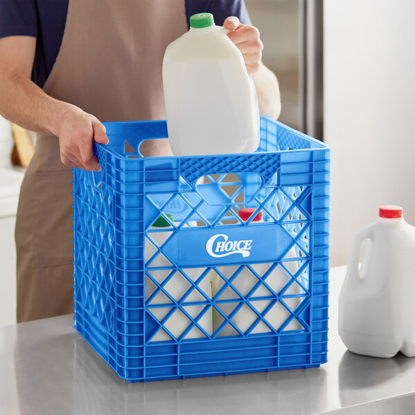 A person holding a white jug of milk in a blue Choice Super Crate.