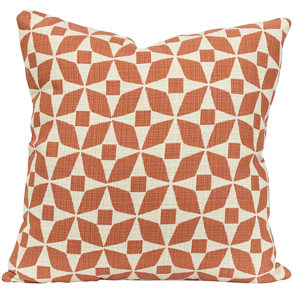 An Astella peach and white outdoor throw pillow with a geometric pattern.
