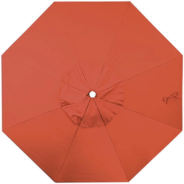 A close-up of an orange California Umbrella replacement canopy with a hole in the middle.