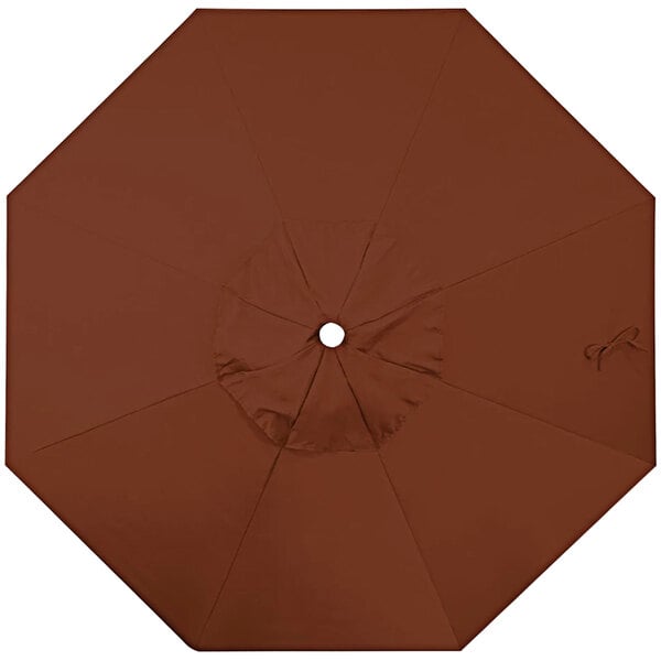 A close-up of a brown California Umbrella replacement canopy with a hole in the middle.