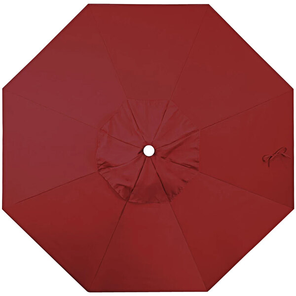 A red umbrella canopy with a white button in the middle.