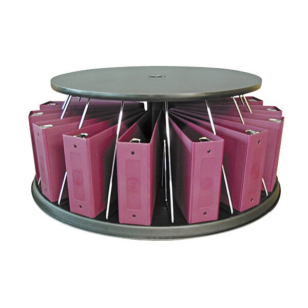 A white countertop carousel with pink binders on it.